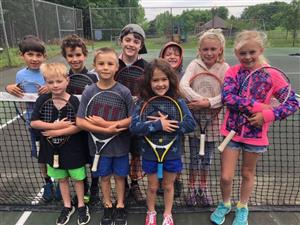 Youth tennis lesson on an outdoor court